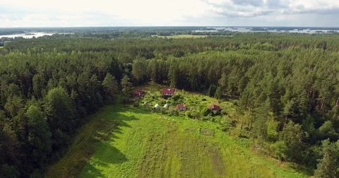 Flyover a farm with big field surround by the wood and lake Stock Footage 85128826