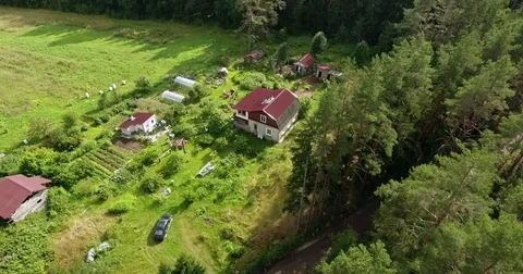 Flyover a farm with big field surround by the wood and lake Stock Footage 85129033