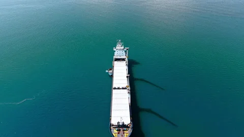 Flyover the long empty cargo ship equipped with two large heavy-lift cranes. Stock Footage 334932368