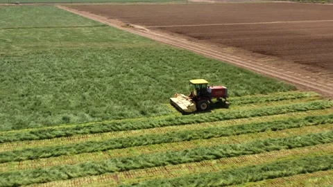 Flyover of man getting in tractor in agricultural field Stock Footage 231816519