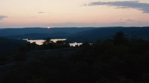 Flyover the mountain over the valley with sunset in the background 4k Stock Footage 116586454