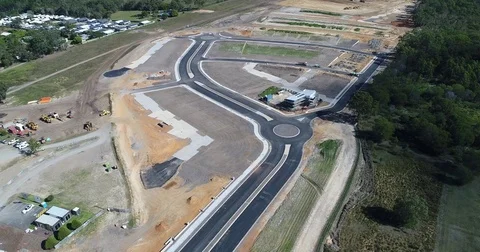 Flyover of new land development by drone revealing mountain horizon Video stock 76311931