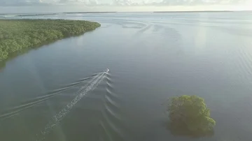 Flyover Ocean View of the Florida Keys of a Small Motorboat Stock Footage 85629028