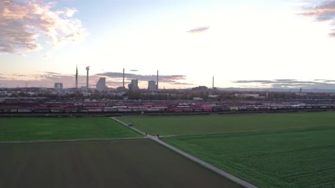 Flyover over Field and Freight Depot at Sunset  Vidéo 145073005