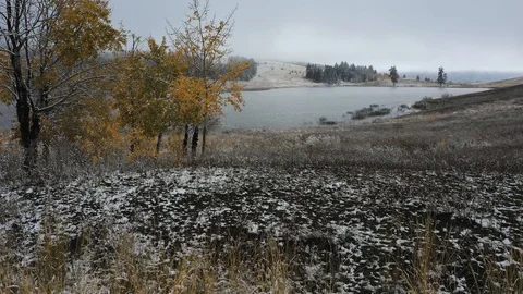 Flyover over field covered in snow and lake in winter Stockbeeldmateriaal 101000582
