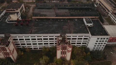 A flyover over the main building of the abandoned factory. Nature takes over. Stock Footage 218450307