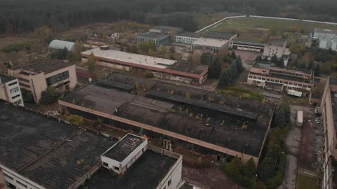 A flyover over the main building of the abandoned factory. Nature takes over. Stock Footage 218450655
