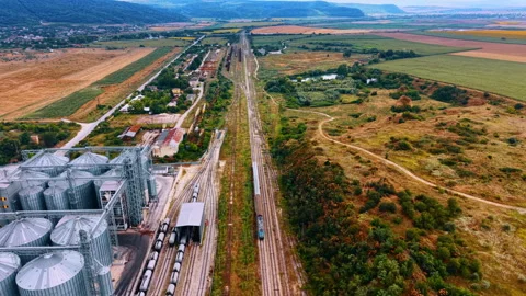 Flyover the railways with a quick train moving by. Footage near the tanks with Stock Footage 340360090
