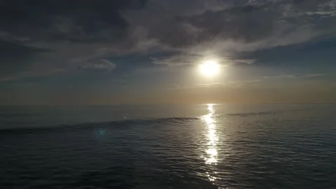 Flyover of Rolling Waves Crashing at Sunset in Crystal Cove Stock Footage 157190773