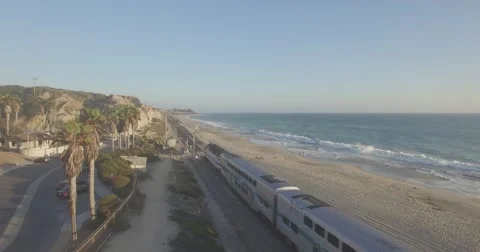 Flyover of the San Clemente State Beach and Metrolink Train Passing Stock Footage 67407852