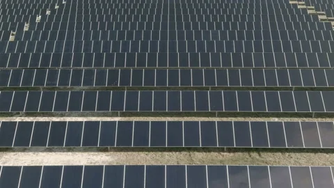 Flyover of seemingly endless solar farm with reflection of clouds Stock Footage 145296025