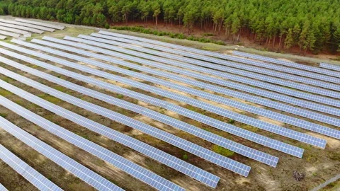 Flyover  shot of solar panel field in forest Stock Footage 135523271