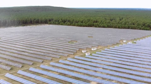 Flyover solar panels in forest during daytime renewable energy aerial shot Stock Footage 134822314