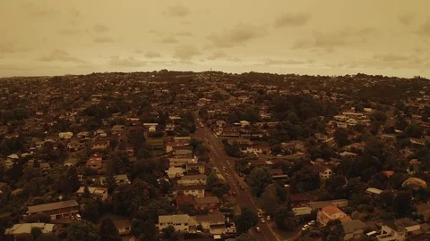 Flyover suburb under orange sky low height 4K HDR 10bit Stock Footage 122265857