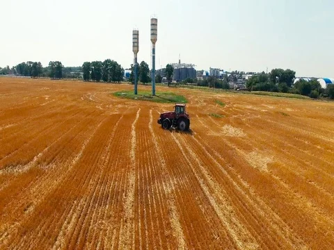 The flyover of the tractor in the field Stock Footage 73421189