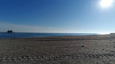 Flyover tractor trails in sand Overlook Beach Stock Footage 102847211