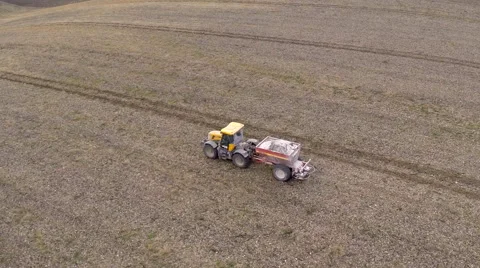 Flyover of Tractor working in field Stock Footage 46858981