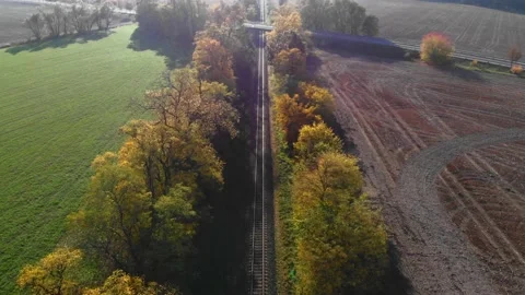 Flyover train tracks towards bridge and road with moving cars Stock Footage 135532459