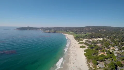 A flyover the white sands of Carmel Beach in California with the ocean and Stock Footage 101245516
