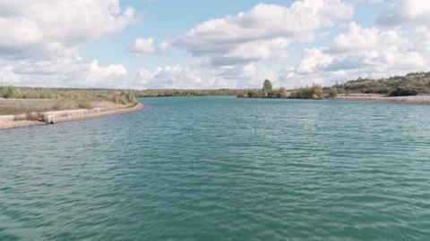 Flythrough Of Lake Surrounded By Trees And Bushes, Cloudy Sky Stock-Footage 132425857
