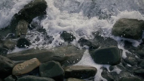 Foam and bubbles from the wave on the stones slow motion Stock Footage 81521626