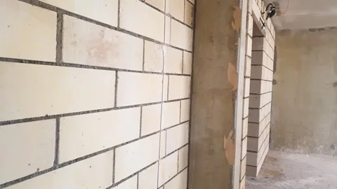 Foam block wall. Block construction, gas silicate block partition Stock Footage 345743047
