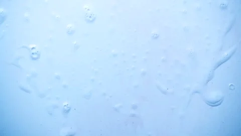 Foam bubbles background. Moving Soap foam popping bubble, blue backdrop.  Stock Footage 296021413