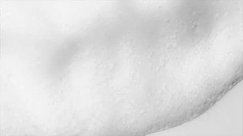 Foam bubbles background. Moving Soap foam popping bubble, white backdrop. Soap Stock Footage 310522293