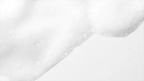 Foam bubbles background. Moving Soap foam popping bubble, white backdrop. Soap Stock Footage 311380389
