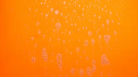 Foam bubbles from soap flowing on orange background. Stock Footage 120075073