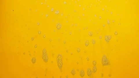 Foam bubbles from soap flowing on yellow background. Video stock 120074986