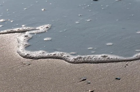 Foam bubbles of a soft wave Stock Photos