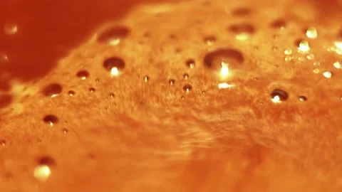 Foam with bubbles on surface of boiling cocoa, coffee chaotically rotating. Stock Footage 205914328