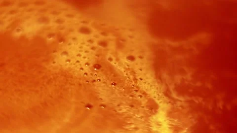 Foam with bubbles on the surface of boiling cocoa, high angle coffee close-up. Stock Footage 205914332