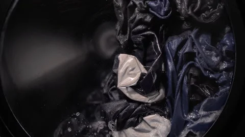 Foam clothes spinning in the washing machine in super slow motion. Stock Footage 212387951