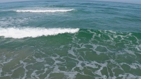 Foam coastal wave rolled on the sandy shore Stock Footage 53953009