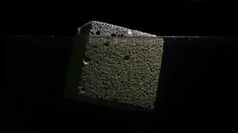 Foam concrete cube floating in water laboratory test Stock Footage 250345180
