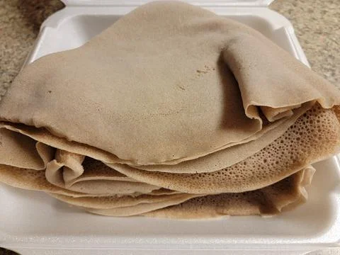 Foam container with stack of Ethiopian bread called injera 스톡 사진