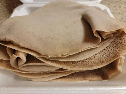 Foam container with stack of Ethiopian bread called injera Stock Photos