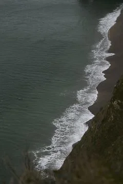 The foam created by the waves, which washes up on the shore, view from the .. Stock Photos