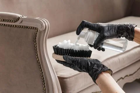 Foam detergent on brush for professional sofa upholstery stain removal Stock Photos