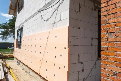 Foam facade insulation, external wall cladding, adhesive fixing, mounting p.. Fotos de archivo