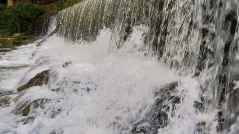 Foam falling from waterfall of river waterfall in slow motion Stock Footage 124390054