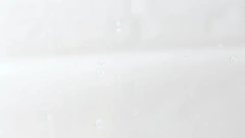Foam flowing down a transparent glass surface, slow motion. Stock Footage 170476527