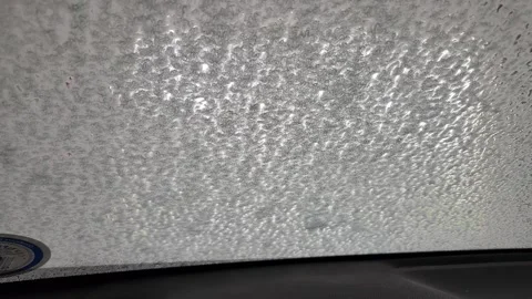 Foam flowing down windshield during automatic car wash, interior view Stock Footage 326436457