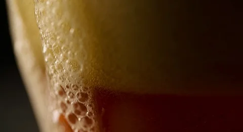 Foam is flowing on side of Beer Glass slow motion 4K Stock Footage 103638441