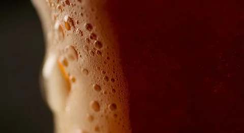 Foam is flowing on side of Beer Glass slow motion Stock Footage 103638488