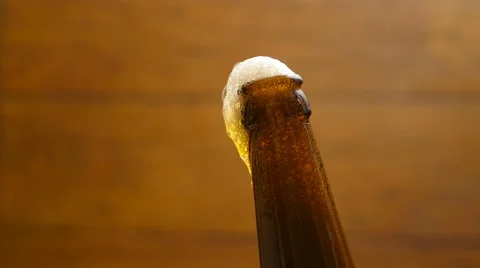 Foam flows down on a brown beer bottle (No 1.1) Stock Footage 67295905