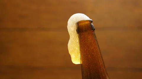 Foam flows down on a brown beer bottle (No 1.2) Stock Footage 67296083