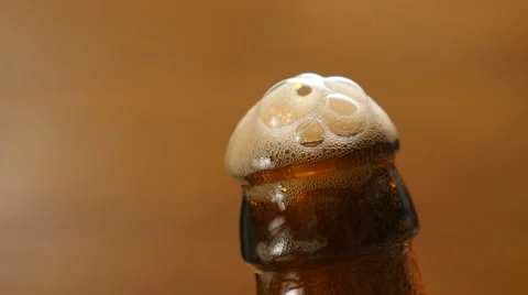 Foam flows down on a brown beer bottle (No 1.5) Stock Footage 67297154